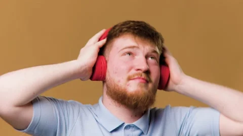 A teenage boy in a studio setting is fully Stock Footage 234691872