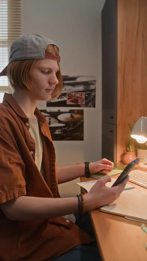 Teenage Boy Studying and Using Smartphone for Online Learning Stock Footage 340790304