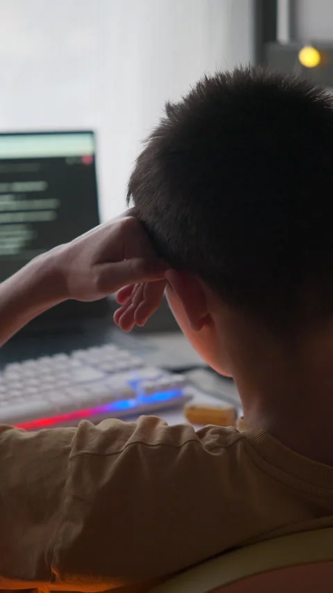 Teenage Boy Thinking While Coding or Studying at Home Vertical Video Stock Footage 323459983