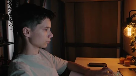 Teenage Boy Typing on Computer Keyboard at Desk at Night Stock Footage 344967867