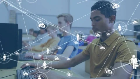 Teenage boy typing in computer lab and activating mic icon forming cloud Stock Footage 326037428