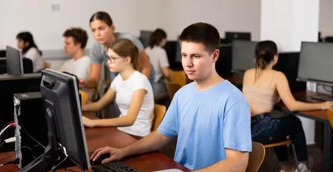 Teenage boy using computer during lesson 库存照片
