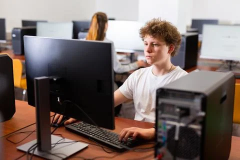 Teenage boy using computer during lesson 스톡 사진