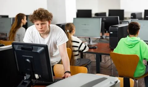 Teenage boy using computer during lesson 스톡 사진