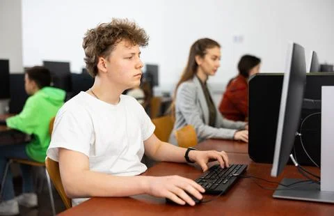 Teenage boy using computer during lesson Foto stock