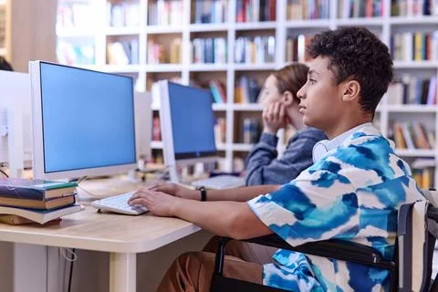 Teenage boy using computer in school 스톡 사진