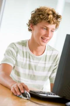 Teenage boy using desktop computer Stock Photos