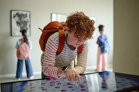 Teenage Boy Using Interactive Screen on School Field Trip in Art Gallery Stock Photos