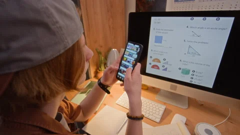 Teenage Boy Using Smartphone Instead of Doing Math Homework Stock Footage 340783273