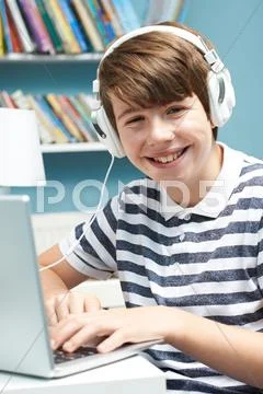 Teenage Boy Using Technology In Bedroom Stock Photos