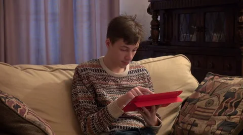 Teenage boy working with a tablet computer at home, typing a message, email Stock Footage 33795825