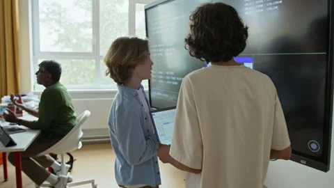 Teenage Boys Learning Coding with Laptop at Interactive Screen 스톡 동영상 342810912
