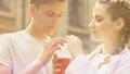 Teenage couple drinking soda together from one cup, romantic relations, love HD Footage