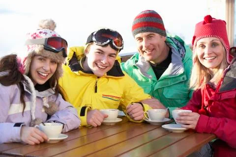 Teenage Family Enjoying Hot Drink In Caf̩ At Ski Resort Stock Photos