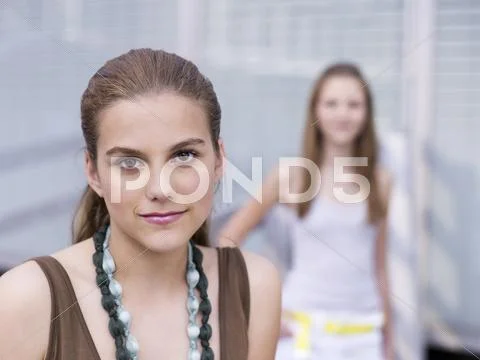 Teenage girl (16-17) wearing necklace, close-up Stock Photos