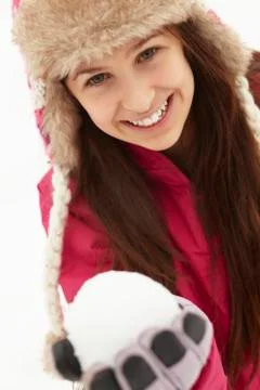 Teenage Girl Holding Snowball Wearing Fur Hat Stock Photos