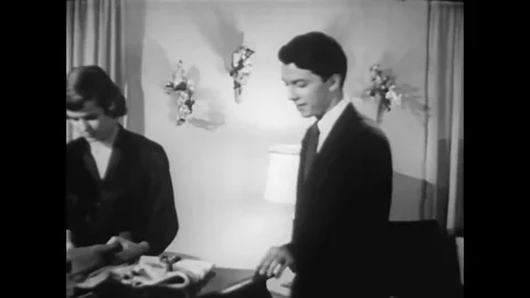 A teenage girl introduces her brother's college roommate to her friends at a Stock Footage