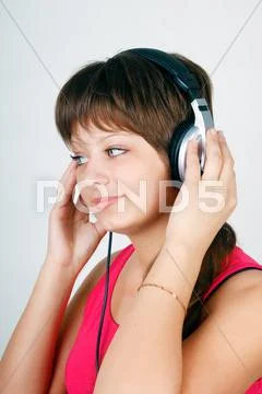 Teenage girl listening to music on headphones Stock Photos