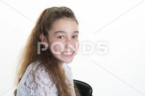 Teenage girl with long hair looking at camera with smile Stock Photos