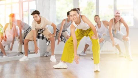 Teenage girl practicing basic hip hop moves in training hall 写真素材