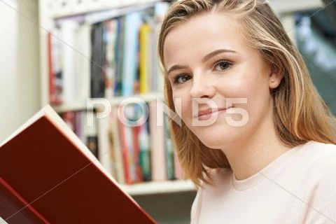Teenage Girl Reading Book At Home Stock Photos