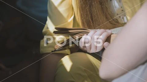 Teenage Girl Reading a Book - telephoto close up Stock Photos