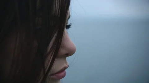 Teenage girl sad, alone, in front of a lake Stock Footage