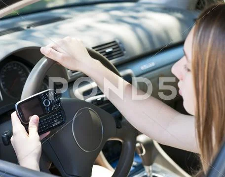 Teenage girl texting and driving Stock Photos