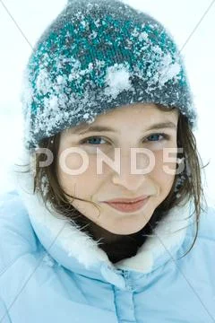 Teenage Girl Wearing Winter Clothes In Snow, Close-Up, Portrait