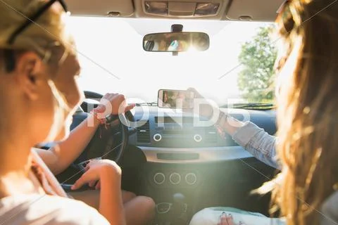 Teenage girls or women with smartphone in car Stock Photos