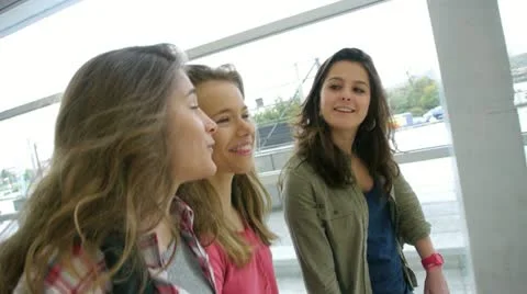 Teenage girls walking in high-school hall Stock Footage
