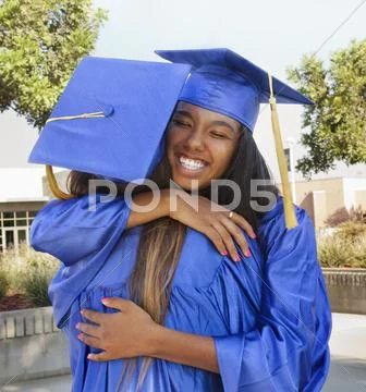 Teenage graduates hugging Stock Photos