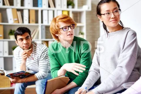 Teenage guy explaining his idea to teacher at lesson Stock Photos