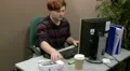 Teenage office worker answers a telephone call HD Footage