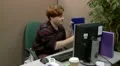 Teenage office worker checks files in a panic but finds good news HD Footage