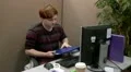 Teenage office worker struggling to find information in files HD Footage