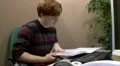 Teenage office worker struggling to find information in files HD Footage