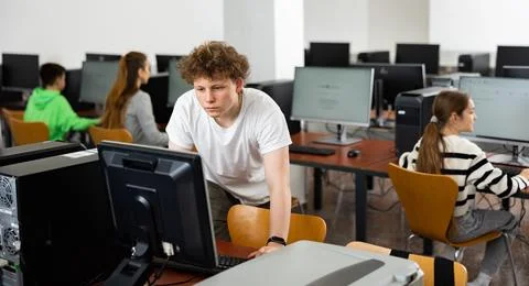 Teenage student learning basics of programming in computer college Stock Photos