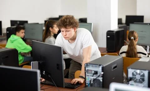 Teenage student learning basics of programming in computer college Stock Photos