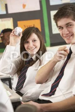 Teenage Students Misbehaving In Classroom Stock Photos