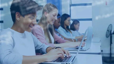 Teenage students typing on laptops in computer lab, showing floating code Stock Footage 309111987
