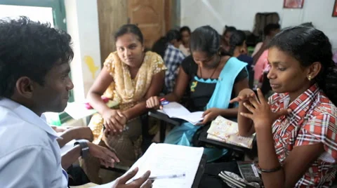Teenage students working together in classroom Stock Footage