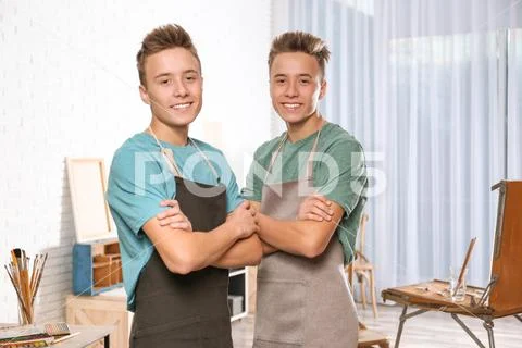 Two happy affectionate young brothers posing leaning on a wooden table with  their arms around each..., Stock Photo, Picture And Low Budget Royalty Free  Image. Pic. ESY-032911432 | agefotostock