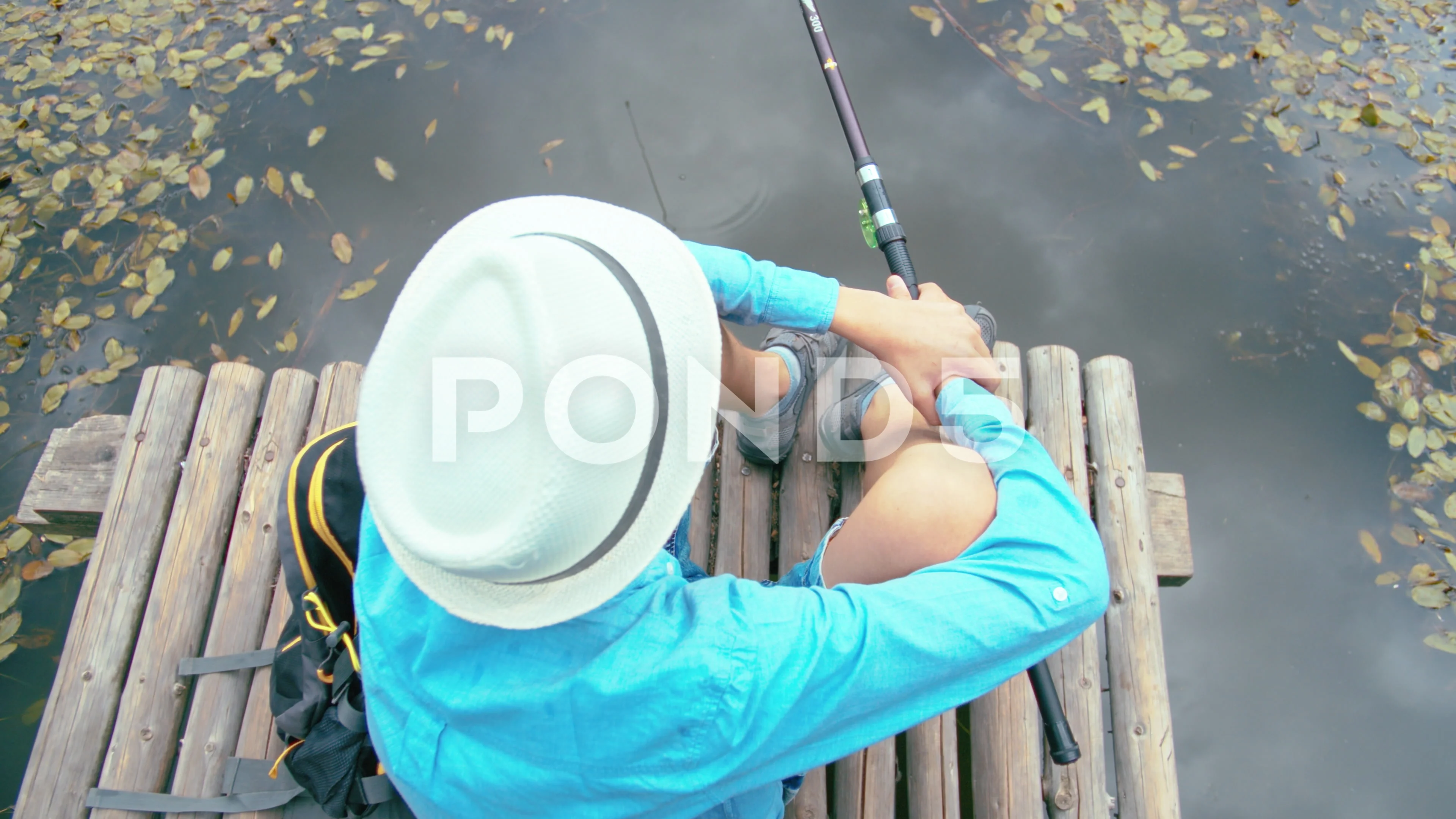 teenager boy with a fishing rod sits on , Stock Video