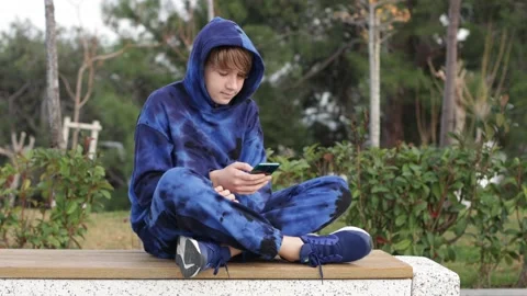 Teenager Boy Playing Games, Using  Mobile Phone. Hold Phone In Hands. Stock Footage 230986973