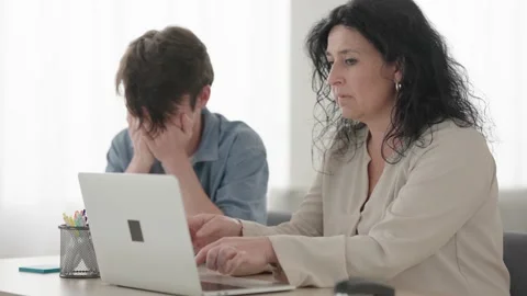 Teenager boy teaching computing to beginner mother Stock Footage 239445109