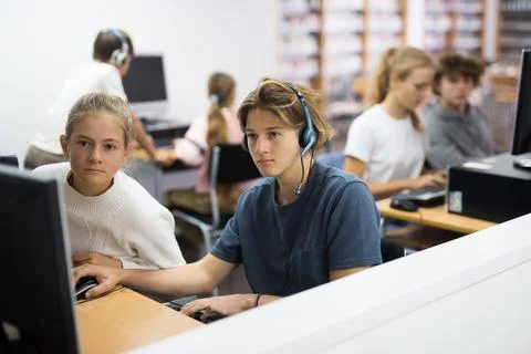 Teenager boy using computer in library Fotos Stock