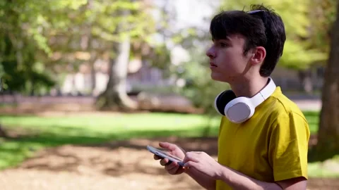 Teenager boy using gps application on phone Stock Footage 252875883