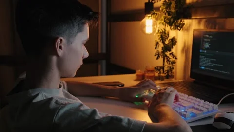 Teenager Coding on Computer at Night at Home Desk 库存影片 344967755