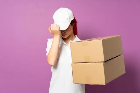 Teenager delivery girl isolated on purple background with headache Stock Photos